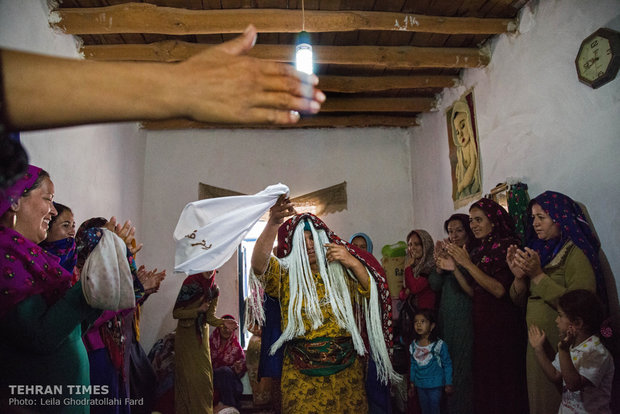 A day after the wedding ceremony the guests perform a game that whoever gets to take off the white cloth wrapped around the bride’s head sooner would be the winner. The winner celebrates her victory.