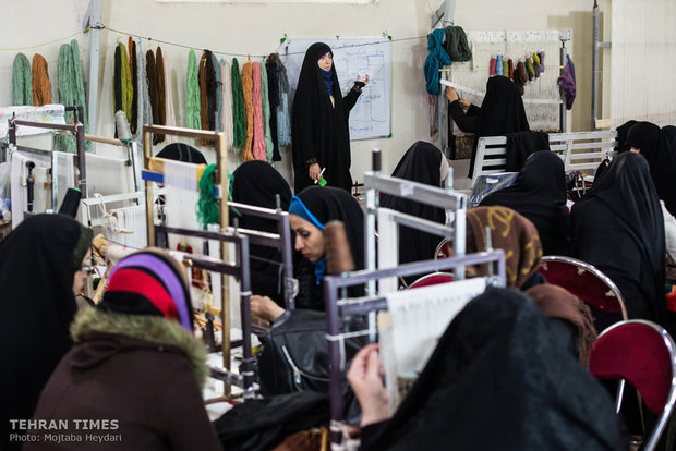 In addition to carpet weaving Hosseini is holding a workshop to teach dressmaking to the trainees.