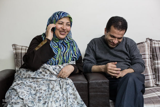 Sitting next to her husband, Hosseini is talking on the phone with her mother who lives in Bijar.