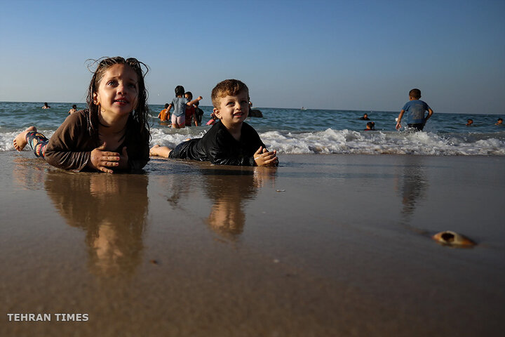 ‘Our only outlet’: Palestinians in Gaza go to the beach during Israel truce