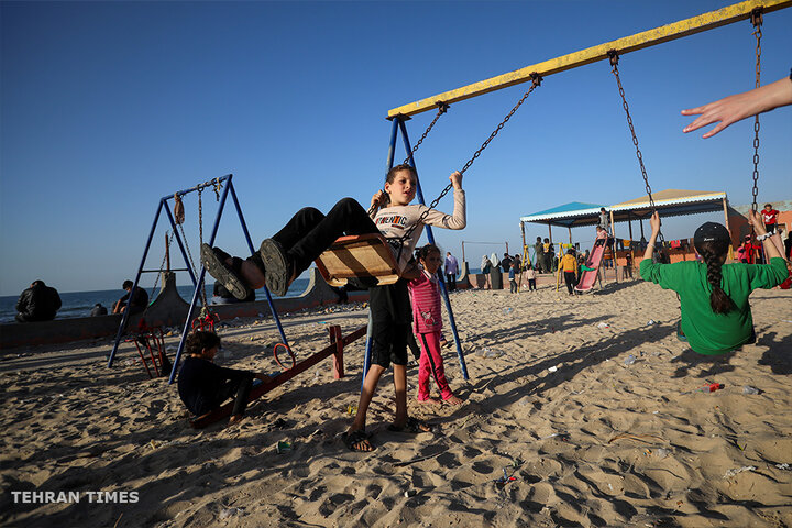 ‘Our only outlet’: Palestinians in Gaza go to the beach during Israel truce