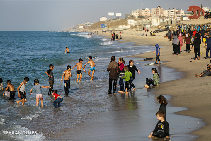 ‘Our only outlet’: Palestinians in Gaza go to the beach during Israel truce