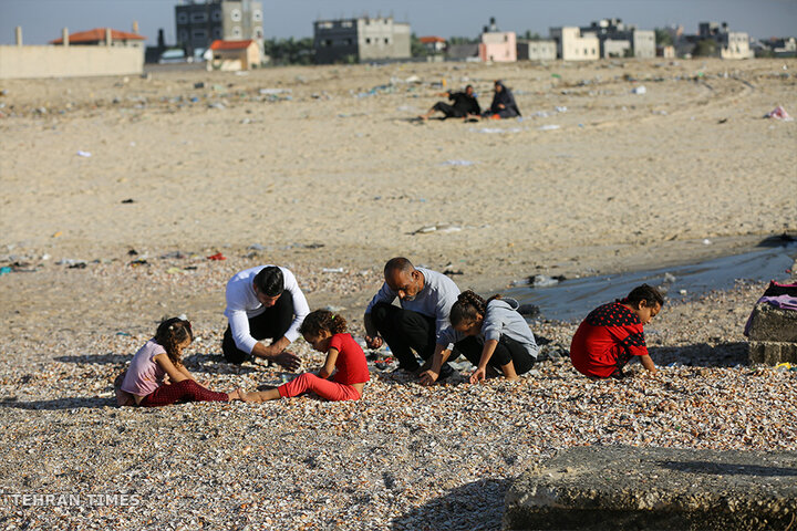‘Our only outlet’: Palestinians in Gaza go to the beach during Israel truce