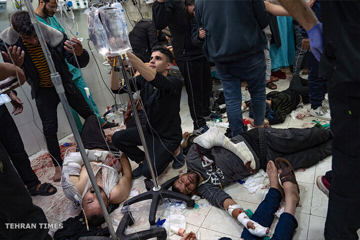 Palestinians are treated as they lie on a hospital floor in Khan Younis after being wounded in an Israeli strikes. [Fatima Shbair/AP Photo]
