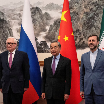 Iranian Deputy Foreign Minister Kazeem Gharibabadi, stands with Chinese Foreign Minister Wag Yi and Russian Deputy Foreign Minister Sergey Ryabkov before a meeting regarding the Iranian nuclear issue