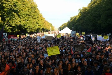 Protesters gather near the Brandenburg Gate in the centre of Berlin.