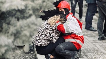 Aid worker comforts an Iranian women after a U.S.-Israeli airstrike in Tehran