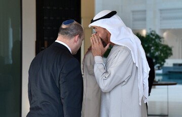 UAE Crown Prince Sheikh Mohammed bin Zayed is seen whispering to then-Israeli Prime Minister Naftali Bennett in Abu Dhabi on December 13, 2021.