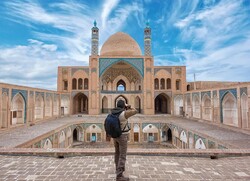 A man takes photos of the historical Agha Bozorg Mosque in Kashan, central Iran.