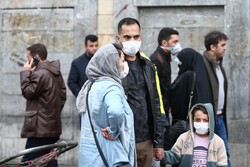 File photo depicts an Iranian family wearing protective masks to prevent contracting a coronavirus, as they stand at Grand Bazaar in Tehran, February 20, 2020. (Credit: West Asia News Agency)