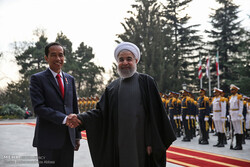 Widodo shaking hand with Rouhani during an official visit to Tehran in mid-Dec. 2016