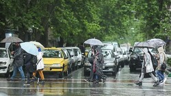 Frequent rain falls in April bring out the umbrellas and rain jackets in Tehran.