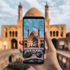 A globetrotter takes a photo of the 19th-century Agha Bozorg mosque, which stands tall in the oasis city of Kashan, central Iran.
