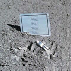 “Fallen Astronaut” statue and a name plaque on the surface of the Moon.