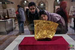 A couple takes a look at the Golden Bowl of Hasanlu, which dates from ca. 900 BC, during a visit to the National Museum of Iran, downtown Tehran.