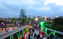 People cross Tabiat Bridge constructed over Modares Highway in Tehran.