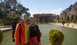 Chinese travelers pose for a photo while standing at the courtyard of Chehel Sotoun, a 17th-century palace in Isfahan, central Iran.