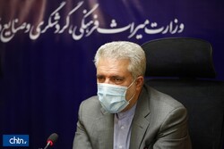 Cultural Heritage, Tourism and Handicrafts Minister Ali-Asghar Mounesan wears a mask while addressing a press conference in an undated photo.