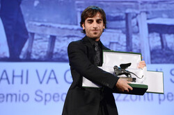 Director Shahram Mokri poses on stage with the Special Orizzonti Award for his movie “Fish and Cat” during the Closing Ceremony of the 70th Venice International Film Festival at the Palazzo del Cinema