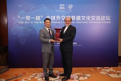 Tehran’s Ambassador to Beijing Mohammad Keshavarz-Zadeh (R) stands by a Chinese official during a meeting on the collective intangible cultural heritage nations have along the ancient Silk Road.