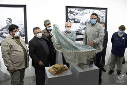 “Children of Ruhollah” organizers unveil a book of the same title during the opening ceremony of the photo exhibition at the Iran Photographers House on September 27, 2020.