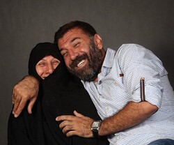 Actor and former footballer Ali Ansarian pose with his mother in an undated photo.