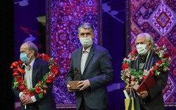 Musicians Hassan Nahid (L) and Mohammareza Es’haqi Gorji (R) accept their lifetime achievement awards from Culture Minister Seyyed Abbas Salehi (C) at the closing ceremony of the 36th Fajr Music Festi
