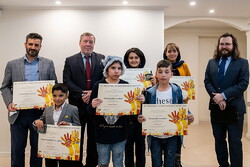 Czech Ambassador Josef Rychtar (2nd L) and a number of his colleagues pose with the Iranian children after honoring them with prizes of the 48th International Children’s Exhibition of Fine Arts Lidice