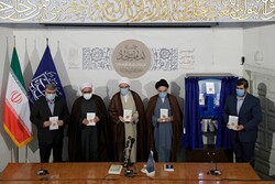 Friday prayers leader Hojjatoleslam Mohammad-Javad Haj-Aliakbari (3rd L) and a number of clerics and Islamic scholars hold copies of “Epic of Imam Sajjad (AS)”