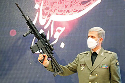 Defense Minister Hatami shows locally-made modern shooting gun