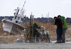 People pray for victims of the March 11, 2011 earthquake and tsunami