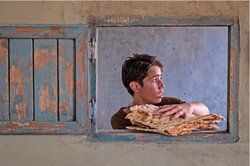 Ruhollah Zamani acts in a scene from director Majid Majidi’s “Sun Children”.