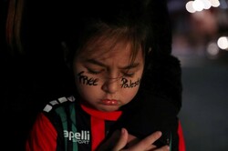 A child attends a protest by Palestinians and pro-Palestinian supporters against Israeli attacks on Gaza amid Israeli-Palestinian fighting, in Santiago, Chile. (Reuters/Ivan Alvarado)