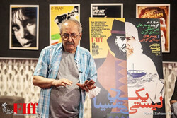 Graphic designer Ebrahim Haqiqi speaks during the opening ceremony of a film poster exhibition at Tehran’s Charsu Cineplex on May 24, 2021. (FIFF/Sahand Taki)    