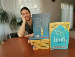 This photo shows Croatian adventurer Ivan Dogic and copies of his book “Iran in the Present”.