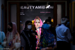 Art enthusiasts visit photographer Fatimah Hossaini’s exhibition “Beauty amid War” at the Iranian Artists Forum in Tehran. (Photo by Ehsan Talebzadeh)  