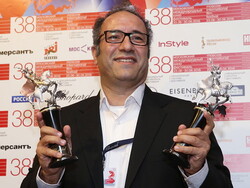 Director Reza Mirkarimi poses with the Golden George awards for his film “Daughter” at the closing of the 38th Moscow International Film Festival on June 30, 2016. (TASS/Vyacheslav Prokofyev)