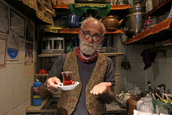Kazem Mabhutian, 63, serves tea at the smallest and oldest teahouse tucked in an alleyway of the Grand Bazaar in the Iranian capital Tehran (PHOTO: ATTA KENARE AFP)