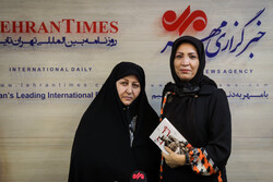 IRGC commander Ahmad Yusefi’s widow Fakhr os-Sadat Musavi (L) and writer Golestan Jafarian pose after a session held at MNA office in Tehran on September 28, 2021 to introduce her memoirs “Autumn Arri