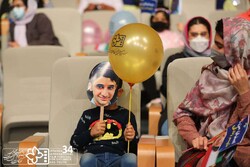 A boy wearing a mask of Ali Landi and his mother attend the opening ceremony of the 34th Isfahan International Film Festival for Children and Youth in Isfahan on October 8, 2021. (ICFF) 