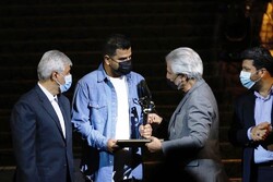 Director Amir Pazirofteh (C) receives the grand prix for his drama “Cylinder” at the 38th Tehran International Short Film Festival from Iranian House of Cinema director Manuchehr Shahsavari