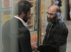 Amir Jadidi and Mohsen Tanabandeh act in a scene from “A Hero” directed by Asghar Farhadi.