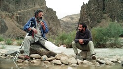 Hassan Majuni and Bahram Ark act in a scene from “Hit the Road”.