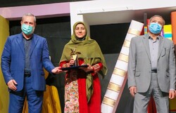 Iranian storyteller Leila Ebrahimi (C) accepts her prize during the 23rd International Storytelling Festival in Tehran on December 21, 2021. (Kanoon/Behzad Khezerlu)