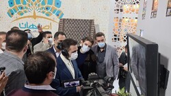 Deputy tourism minister Ali-Asghar Shalbafian, who is encircled by exhibitors, visitors, and reporters, tours the Isfahan pavilion at the 15th Tehran International Tourism Exhibition, January 29, 2022.