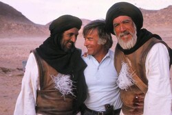 Director Moustapha Akkad (C) is seen with actors Abdallah Gheith (L) and Anthony Quinn on the set of his 1976 movie “The Message”.