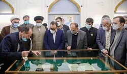 An expert (L) briefs a group of cultural officials visiting an exhibition of artworks and books on poet Nezami Ganjavi at the Astan-e Qods Razavi Museum and Library in Mashhad on March 6, 2022.