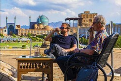 Foreign travelers sip traditional beverages during their visits to the UNESCO-registered Imam Square in Isfahan.