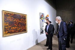Iranian culture minister aide Mahmud Shalui (L) and a number of artists visit the Five Treasures Exhibition at the Tehran Museum of Contemporary Art on March 12, 2022. (Honaronline/Gatha Ziatabari)