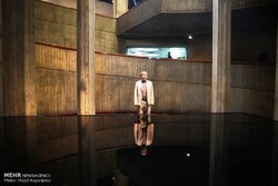 Japanese artist Noriyuki Haraguchi glances at his sculpture “Oil Pool” on display at the Tehran Museum of Contemporary Art on October 21, 2017. (Mehr/Majid Asgaripur)